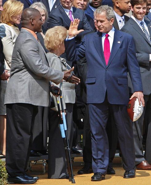 President Bush high-fives Lt Col. Greg Gadson, the New York Giants inspirational co-captain, as they participate in a photo opportunity with the members of the Super Bowl XLII champion New York Giants, Wednesday, April 30, 2008, on the South Lawn of the White House in Washington. Super Bowl most valuable player, quarterback Eli Manning is at right.  (AP Photo/Ron Edmonds)